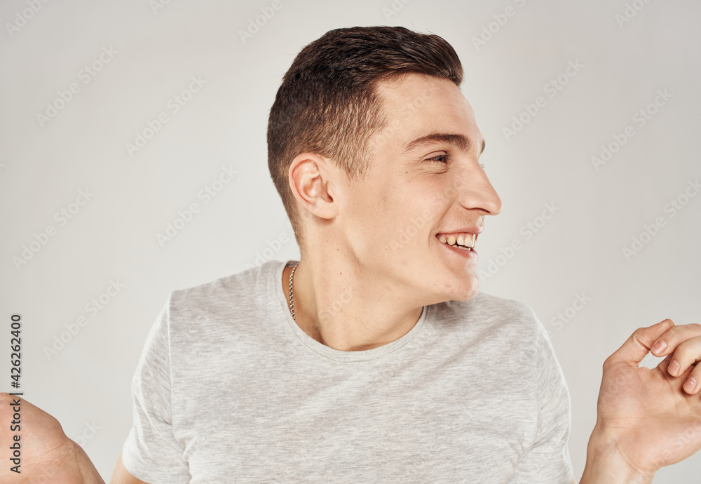 Cheerful man t-shirt emotions hand gestures close-up Cheerful man t-shirt emotions hand gestures close-up