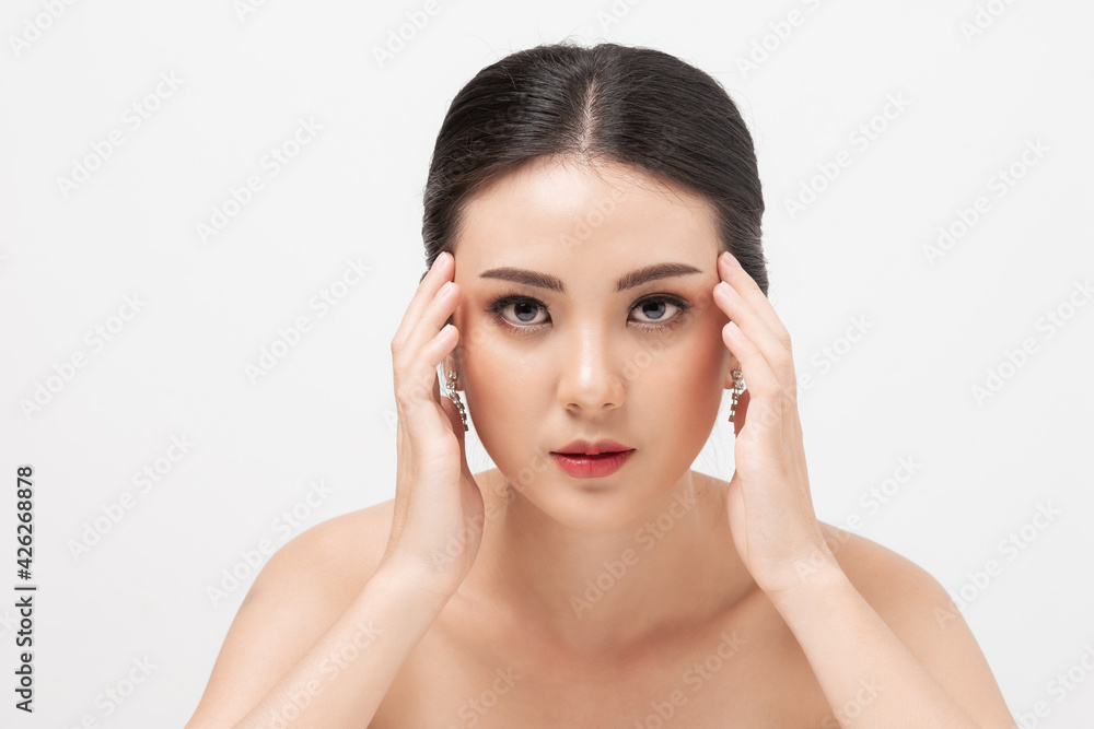 Serious woman thinking. Portrait Asian female anxious and hands holding temples on white background. Mental health and anxiety of woman about skin problems her face. Serious woman thinking. Portrait Asian female anxious and hands holding temples on white background. Mental health and anxiety of woman about skin problems her face.