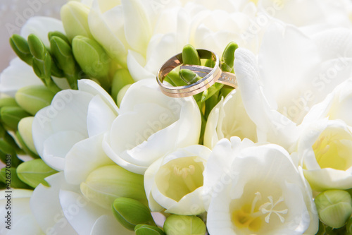 wedding rings made of gold on a bouquet of flowers