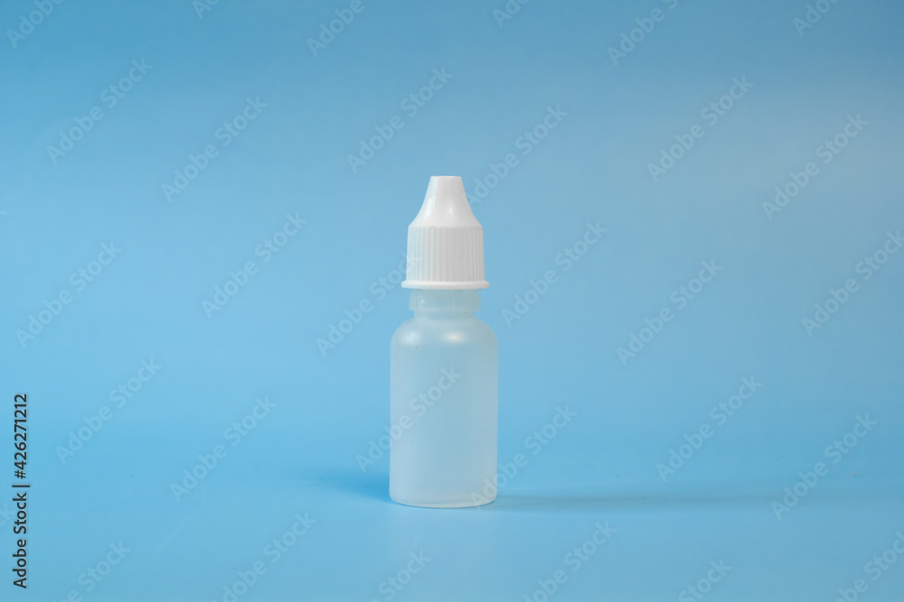 Plastic container for nose and eye drops, bottle. isolated on blue background. Place for an inscription. Copyspace Plastic container for nose and eye drops, bottle. isolated on blue background. Place for an inscription. Copyspace
