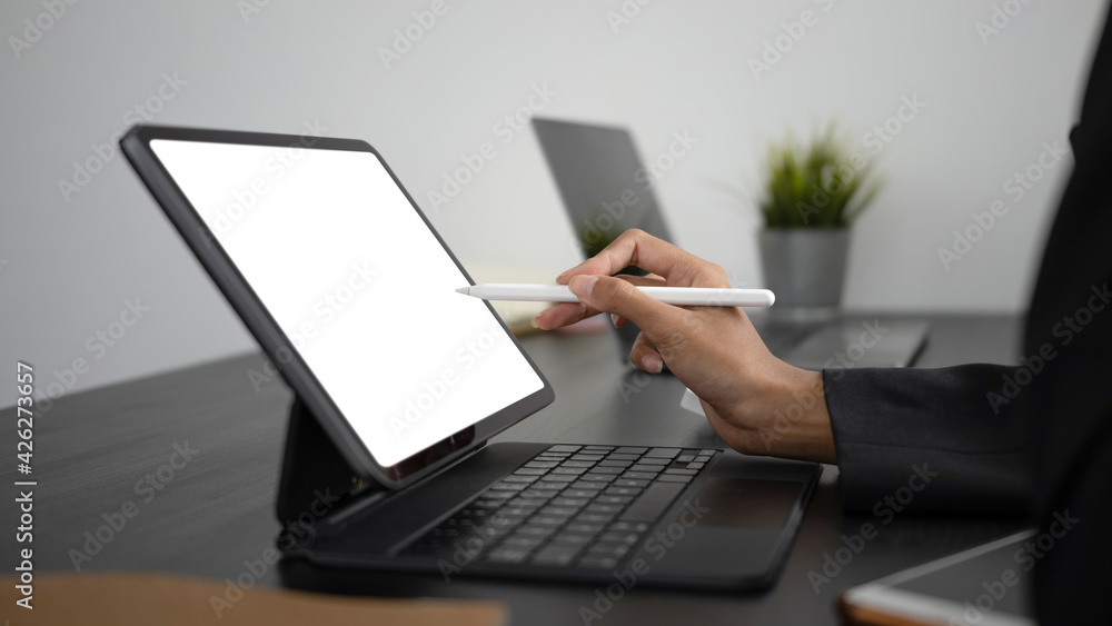 Close up view of businesswoman hands holding stylus pen pointing on empty screen of computer tablet. Close up view of businesswoman hands holding stylus pen pointing on empty screen of computer tablet.