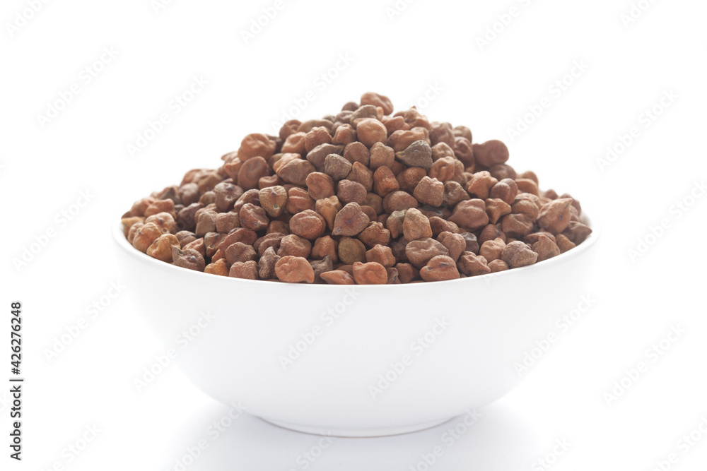 Close-up of Organic chana or chickpea (Cicer arietinum) or whole white Bengal gram dal inside a ceramic white bowl Close-up of Organic chana or chickpea (Cicer arietinum) or whole white Bengal gram dal inside a ceramic white bowl