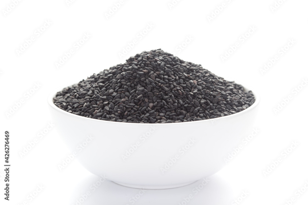 Close up of Organic Black Sesame seeds(Sesamum indicum) or Black Til with shell inside a white ceramic bowl Close up of Organic Black Sesame seeds(Sesamum indicum) or Black Til with shell inside a white ceramic bowl