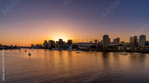 Sun setting over the Vancouver Skyline at the North Shore of False Creek, British Columbia, Canada