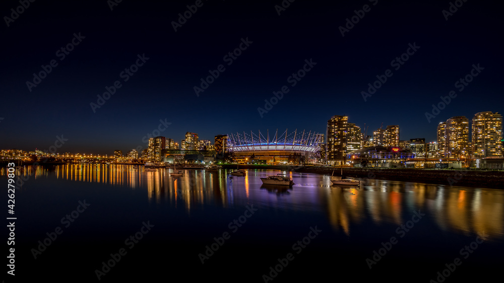 Vancouver Skyline at night with BC Place Stadium Lit Up at the North Shore of False Creek Inlet at night, British Columbia, Canada