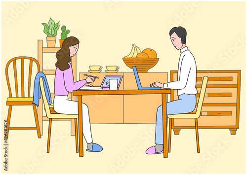 自宅リビングで仕事をしている男性と女性