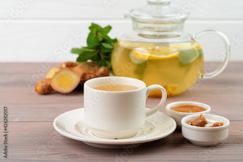 Glass teapot of tea with ginger and citrus