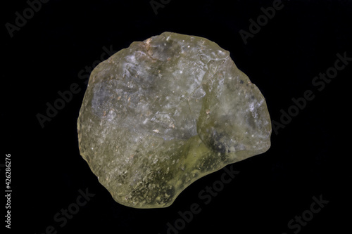Yellow specimen of Libyan desert glass. Translucent to transparent, weighing 45.0 grams. Surface is smooth, mottled, with evidence of flowing motion. Photographed with black background.