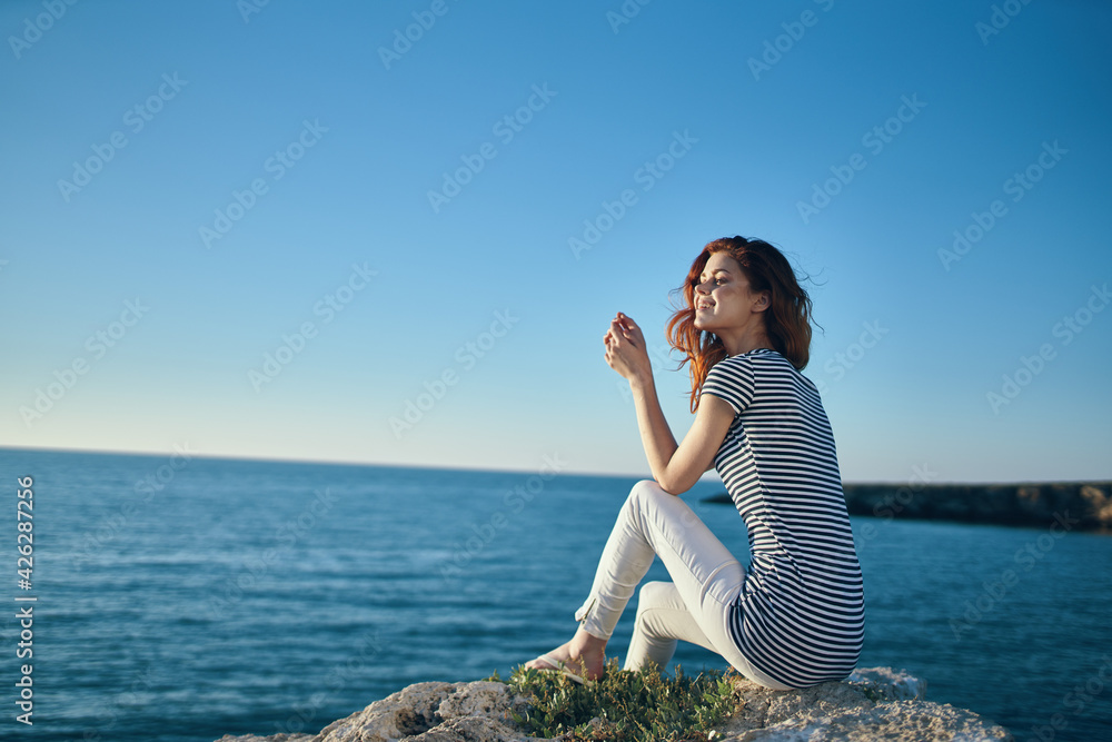 happy traveler on the beach near the sea in the mountains in summer and clear water happy traveler on the beach near the sea in the mountains in summer and clear water