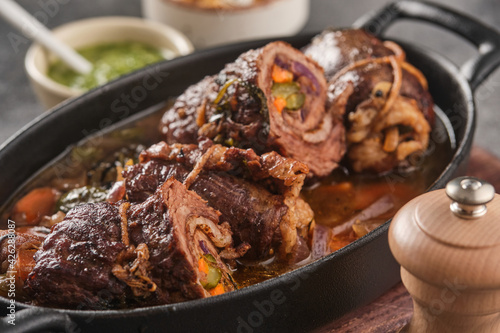 Fotografie Dish of beef, bacon and pickle roulades in gravy seasoned with vegetables for a traditional regional German dinner