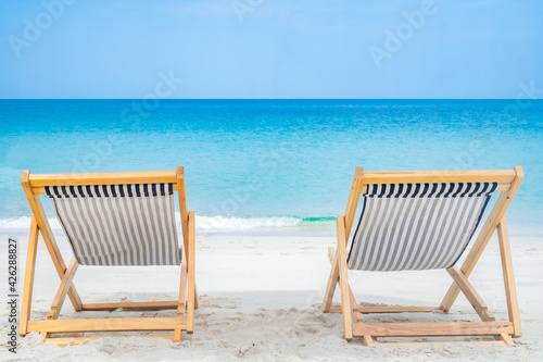 Beach chair on the sand beach sea side in frontwith clear blue sky. nobody background with copy space for text. Summer relax on travel vacation concept.