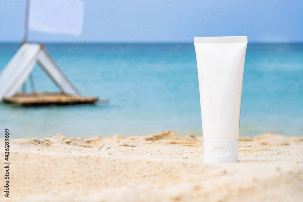 empty cosmetic skin care cream or sun block on sand beach with sea side background travel vacation accessory empty cosmetic skin care cream or sun block on sand beach with sea side background travel vacation accessory
