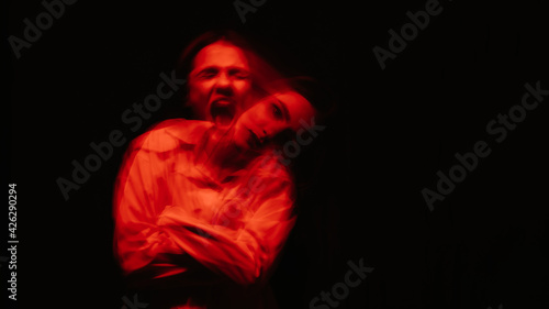 portrait of a psychotic woman with mental disorders and bipolar disease in a white straitjacket