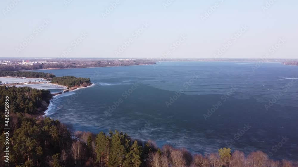Vast frozen lagoon of Kaunas in early spring time, aerial drone view Vast frozen lagoon of Kaunas in early spring time, aerial drone view