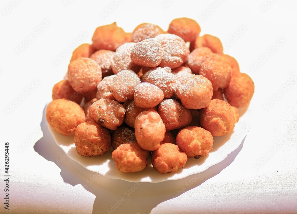 donuts ball with powdered sugar hot outdoors on a plate donuts ball with powdered sugar hot outdoors on a plate