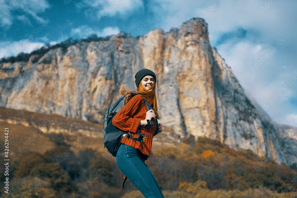 woman tourist with backpack on nature autumn season travel