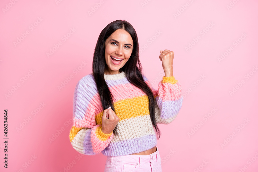 Photo of young excited woman happy positive smile celebrate win victory fists hands isolated over pastel color background Photo of young excited woman happy positive smile celebrate win victory fists hands isolated over pastel color background