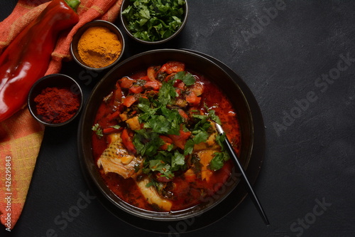 Moroccan fish with chermoula, red peppers and preserved lemon. Spicy traditional Moroccan food