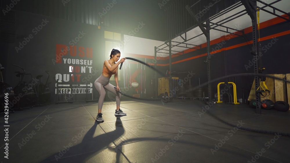 Asian woman doing battle ropes for cardio. Muscle strength training workout  at gym fitness center club. Exercise indoor with sport equipment. Athletic.  People lifestyle. Recreation Stock Photo | Adobe Stock