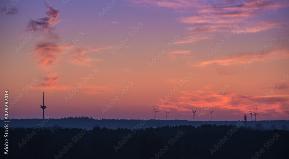 morning sky with windmills and broadcasting tower