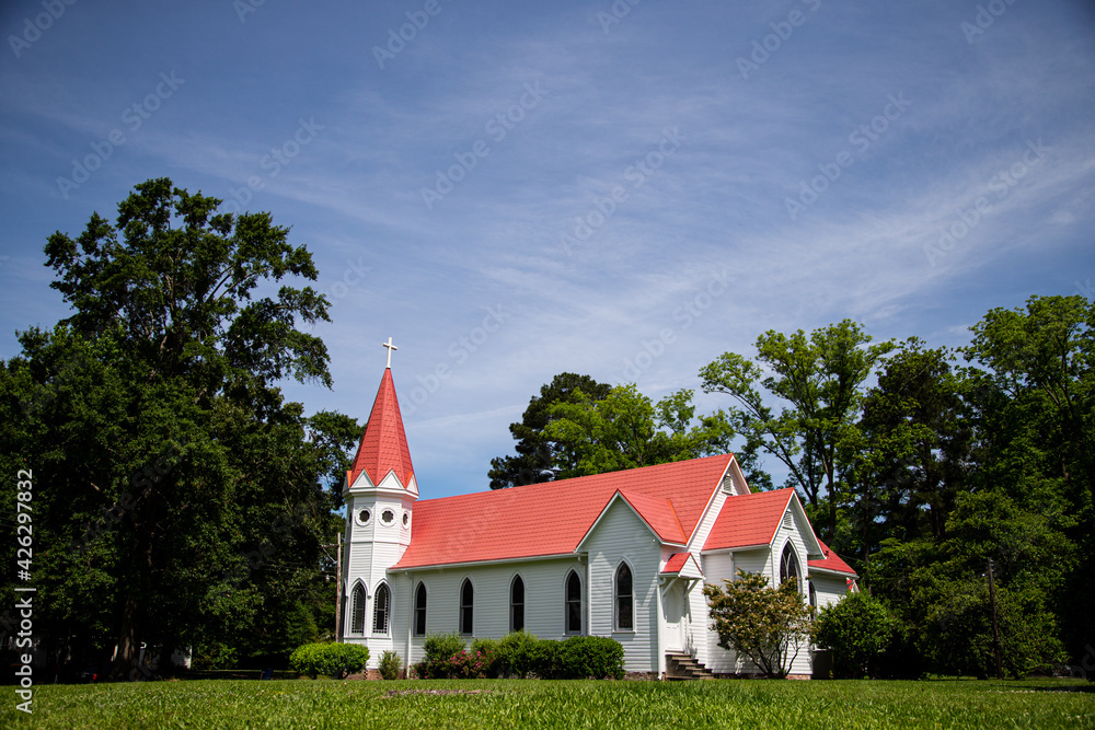 Rural white church with a red roof in Jackson, Mississippi, United States - May 26, 2013 Rural white church with a red roof in Jackson, Mississippi, United States - May 26, 2013