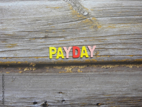 Word Payday on wood background photo