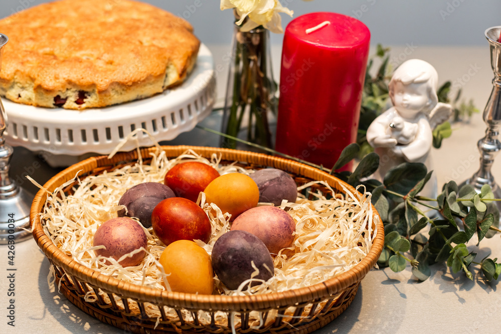 Easter table, basket with painted eggs and cake. Easter table, basket with painted eggs and cake.