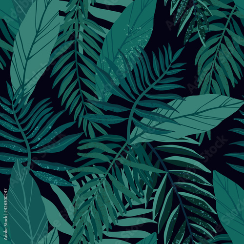 Seamless tropical pattern with exotic palm leaves and various plants on dark background.