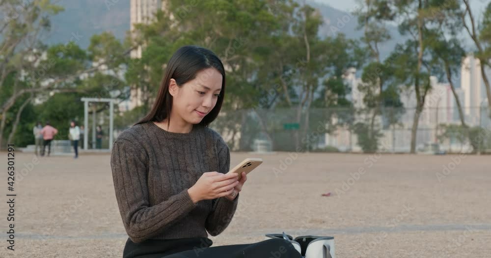 Woman use of mobile phone at park Woman use of mobile phone at park