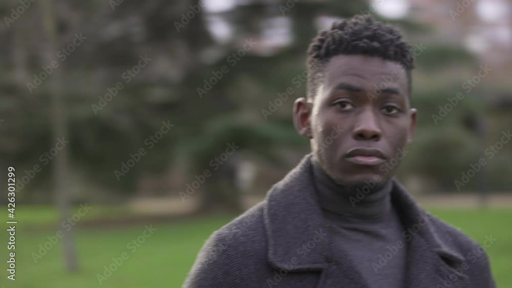 Serious elegant black African man standing outside, circling tracking shot Serious elegant black African man standing outside, circling tracking shot