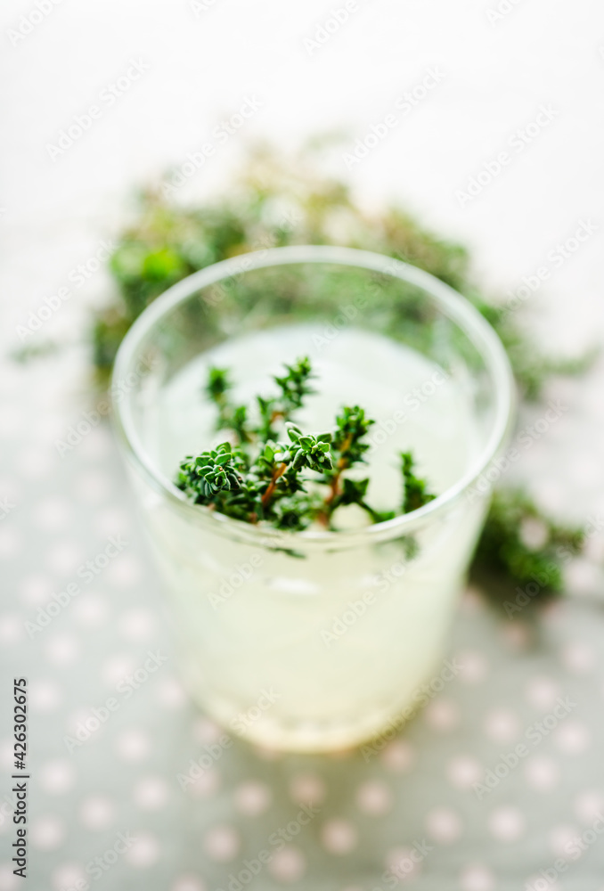 Freshly making gin based old fashioned cocktail with lemon juice and thyme. Selective focus. Shallow depth of field. Freshly making gin based old fashioned cocktail with lemon juice and thyme. Selective focus. Shallow depth of field.