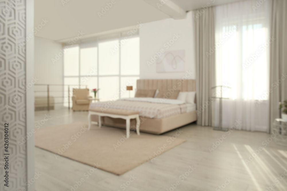 Naklejka premium Blurred view of stylish hotel bedroom interior with modern furniture