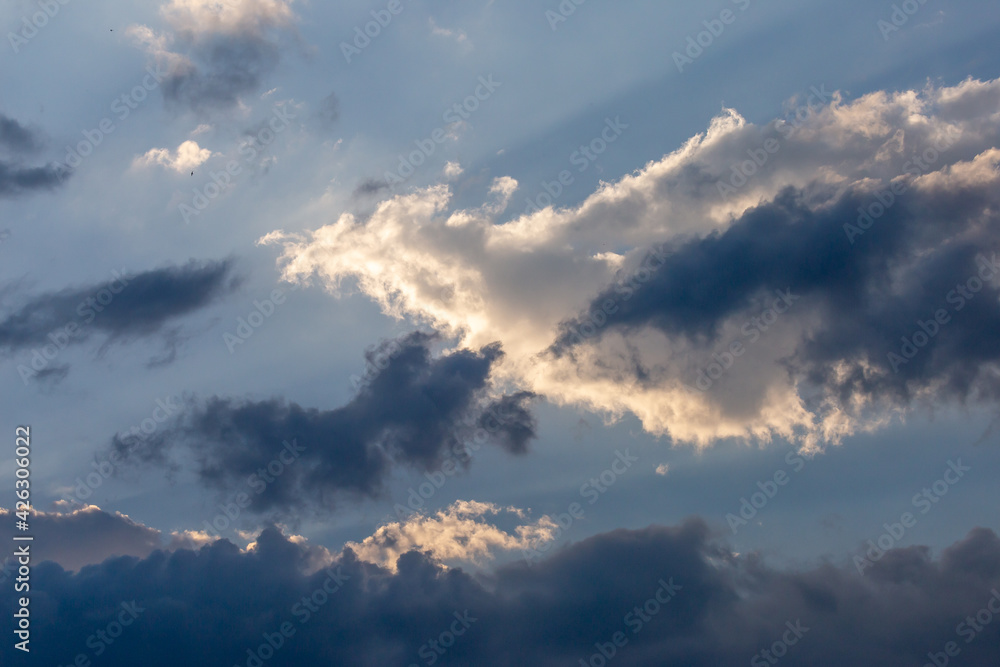 Beautiful white clouds and clear blue sky There is light shining through the clouds that are about to rain. Sky image for background design The blue color makes you feel fresh and bright. Beautiful white clouds and clear blue sky There is light shining through the clouds that are about to rain. Sky image for background design The blue color makes you feel fresh and bright.