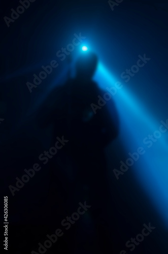 Defocused silhouette of a musician or singer on stage.