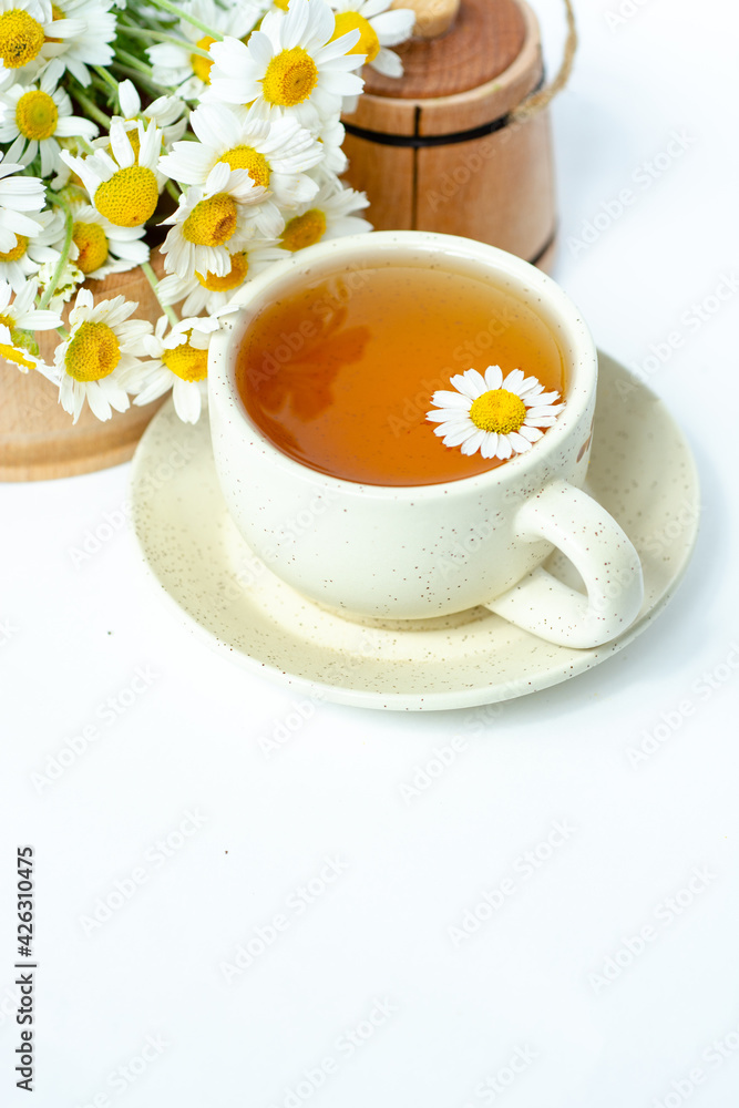 cup of herbal chamomile tea with fresh daisy flowers background, treatment and prevention of immune concept, medicine - folk, alternative, complementary, traditional medicine cup of herbal chamomile tea with fresh daisy flowers background, treatment and prevention of immune concept, medicine - folk, alternative, complementary, traditional medicine