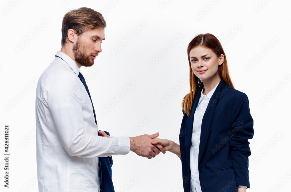 work colleagues shake hands communication contract light background