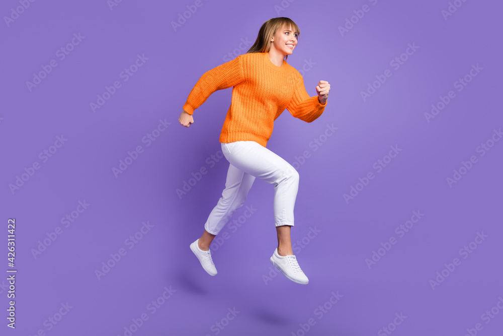 Profile photo of lady jump run fast wear orange sweater trousers footwear isolated violet color background
