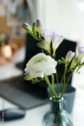 Bouquet of white ranunculus on the desk