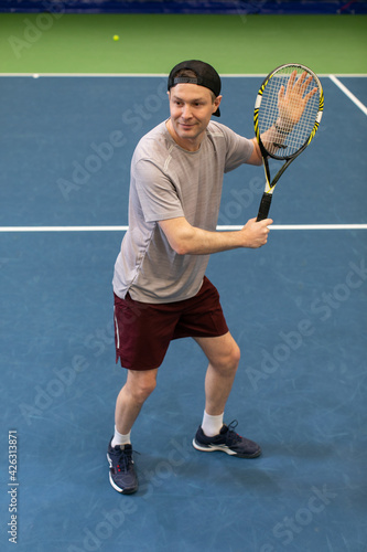 Male tennis player сoncentrated on game. Man waits for the pitch to hit the ball back © Artem Bruk
