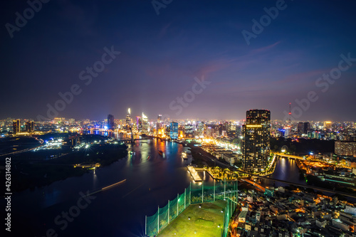 Aerial view of Ho Chi Minh city  Vietnam. Beauty skyscrapers along river light smooth down urban development. Dramatic lighting spectacular night.