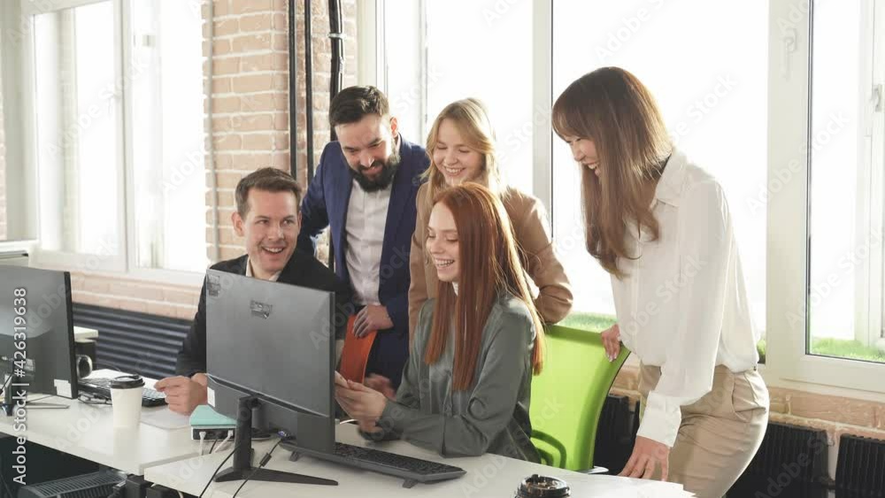 Red-haired girl shows colleagues on a smartphone their photos from vacation, friendly business team during a break. Red-haired girl shows colleagues on a smartphone their photos from vacation, friendly business team during a break.