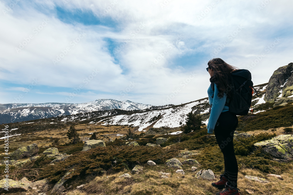 young woman standing looking at mountain landscape. Snowy mountains young woman standing looking at mountain landscape. Snowy mountains