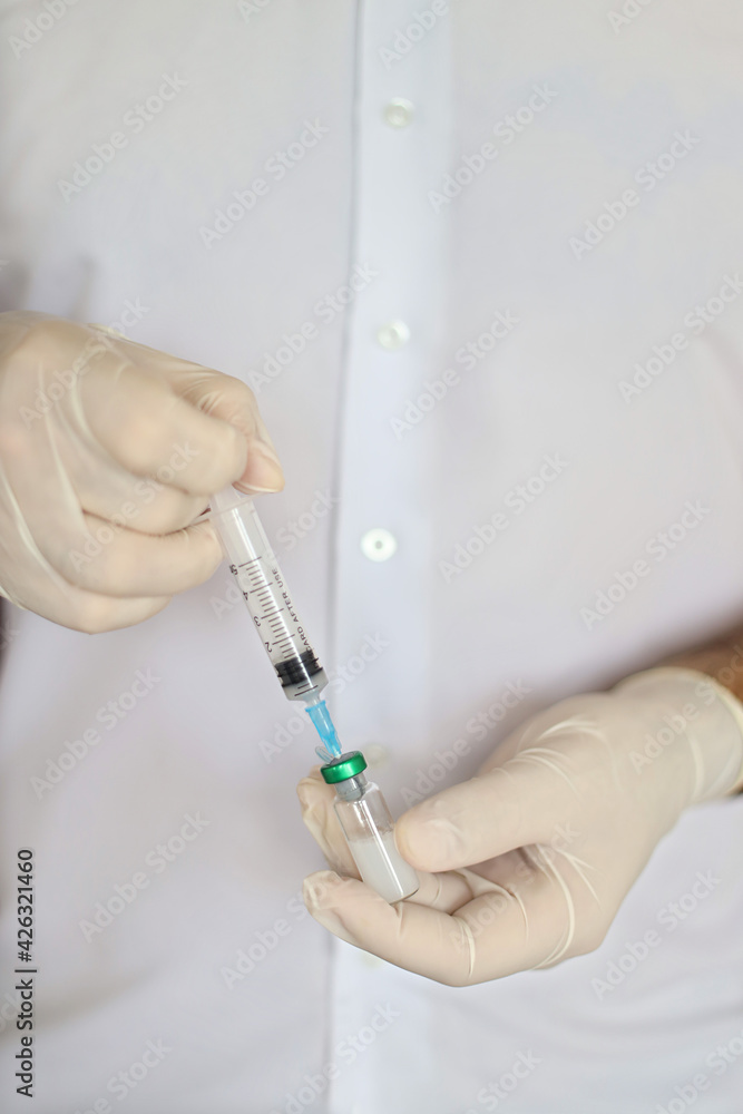 doctor preparing to give coronavirus vaccine, closeup. Vaccination Concept . Flu influenza vaccine clinical trials concept, corona virus treatment. Vertical photo doctor preparing to give coronavirus vaccine, closeup. Vaccination Concept . Flu influenza vaccine clinical trials concept, corona virus treatment. Vertical photo