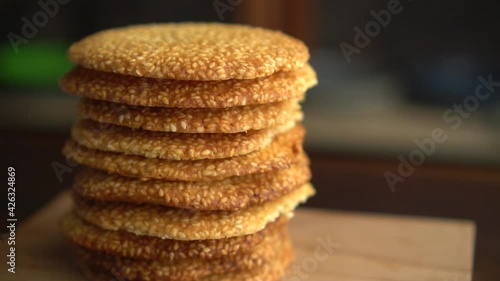 Freshly made sesame seed cookies on a wooden serving board. Cookies on a wooden background with a bokeh effect.