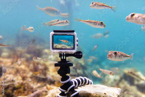 Using action-camera in waterproof box to make photos and video underwater