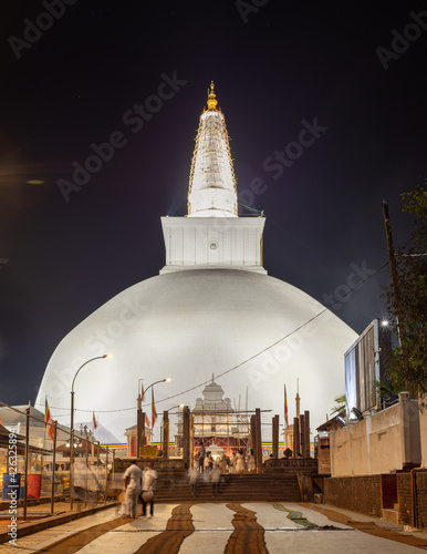 Ruwanwelisaya stupa glowing in the night, it is a hemispherical structure and containing sacred Buddha's relics built by King Dutugamunu. photo