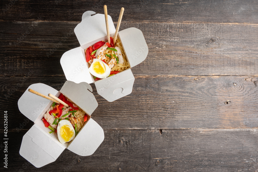Noodles in lunch box with chicken, vegetables and egg. Asian food. Selective focus. Noodles in lunch box with chicken, vegetables and egg. Asian food. Selective focus.