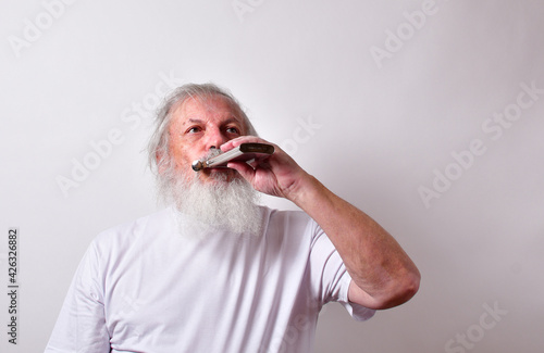 Bilde på lerret Old alcoholic male drinking booze from a flask