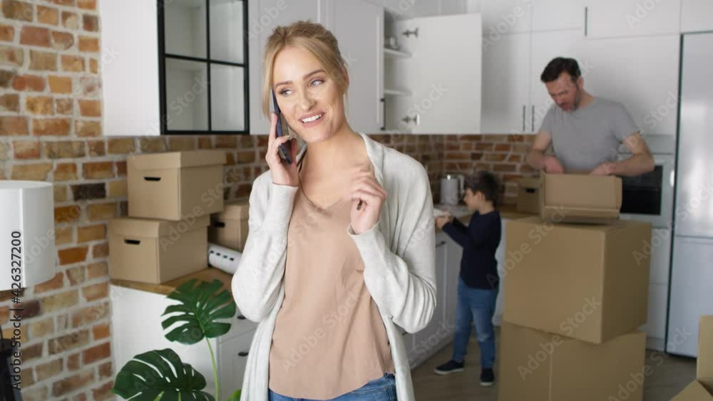 Happy woman calling and holding keys to a new house. Shot with RED helium camera in 8K. Happy woman calling and holding keys to a new house. Shot with RED helium camera in 8K.