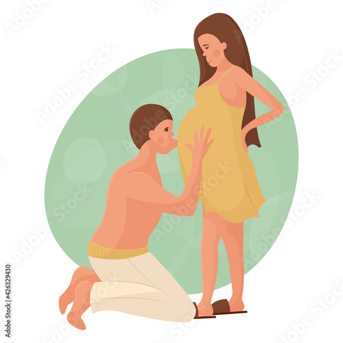Young white couple in love waiting for the birth of a baby. The man is on his knees and kisses his pregnant wife on the stomach. Happy pregnancy and motherhood. Maternity leave for future parents.